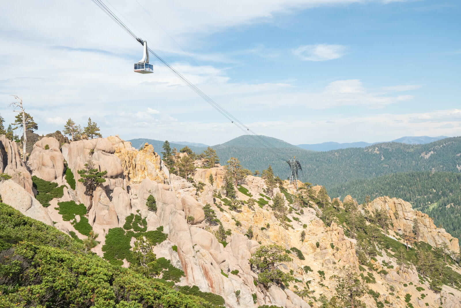 The Palisades Tahoe Tram ascending the cables above the Tahoe Via Ferrata. One of the best Lake Tahoe adventures!