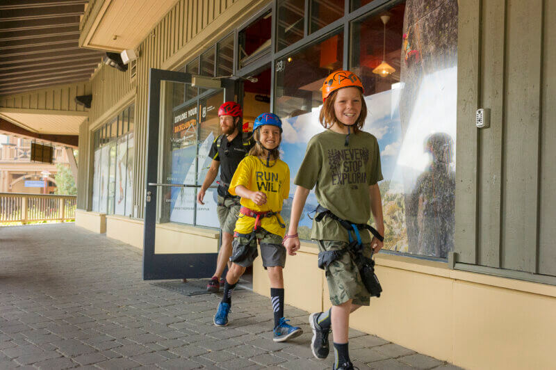 A group of boys all geared up to go climb the Tahoe Via Ferrata at Palisades Tahoe in Olympic Valley. One of the best Lake Tahoe adventures!