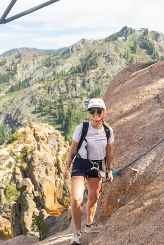 Emily Harrington standing at the top of Tram Face at Palisades Tahoe after climbing the Tahoe Via Ferrata. One of the best Lake Tahoe adventures!
