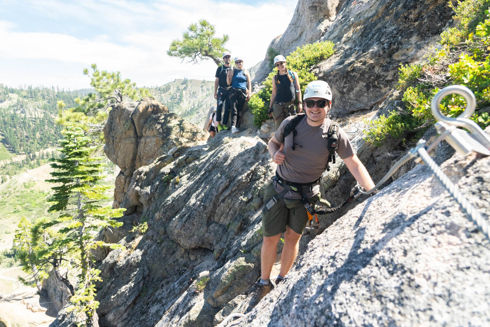 A group climbing the Tahoe Via Ferrata at Palisades Tahoe in Olympic Valley. One of the best Lake Tahoe adventures!